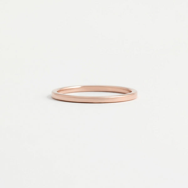 A think, polished rose gold wedding ring.